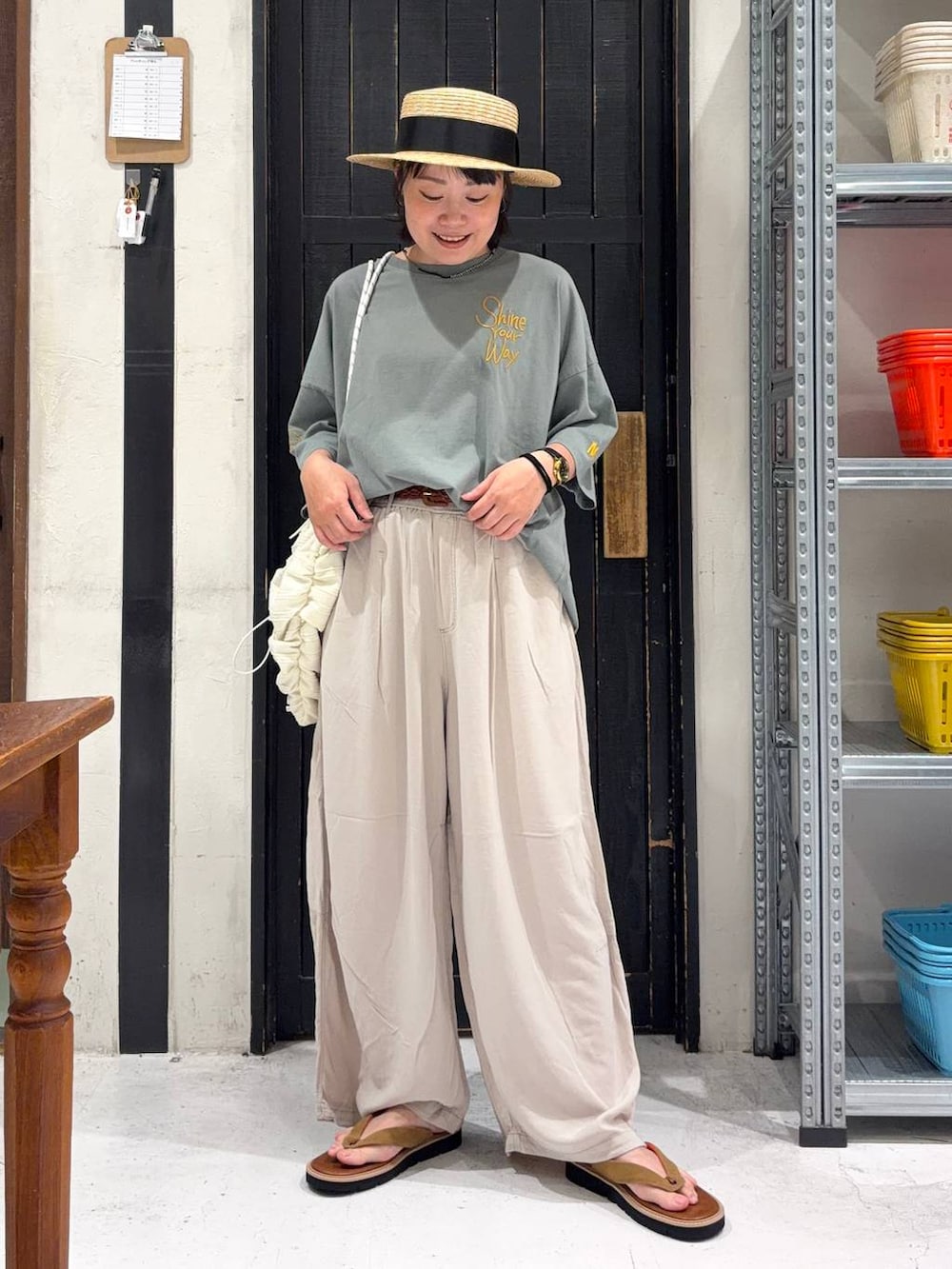 ベージュ系のその他パンツ、ベージュ系のバックパック/リュック、ブラウン系のサンダルを着用したレディースの春コーディネートの3枚目の写真