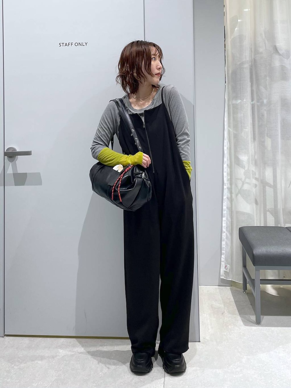 ブラック系のボストンバッグ、ブラック系のローファー、ブラック系のサロペット/オーバーオールを着用したレディースの冬コーディネートの2枚目の写真