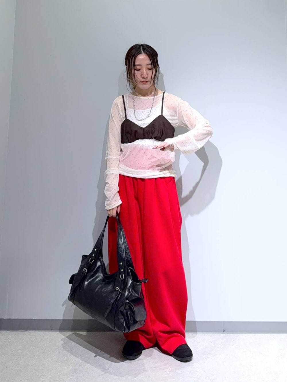 ブラック系のパンプス、ブラック系のトートバッグ、ブラウン系のその他トップスを着用したレディースの夏コーディネートの2枚目の写真