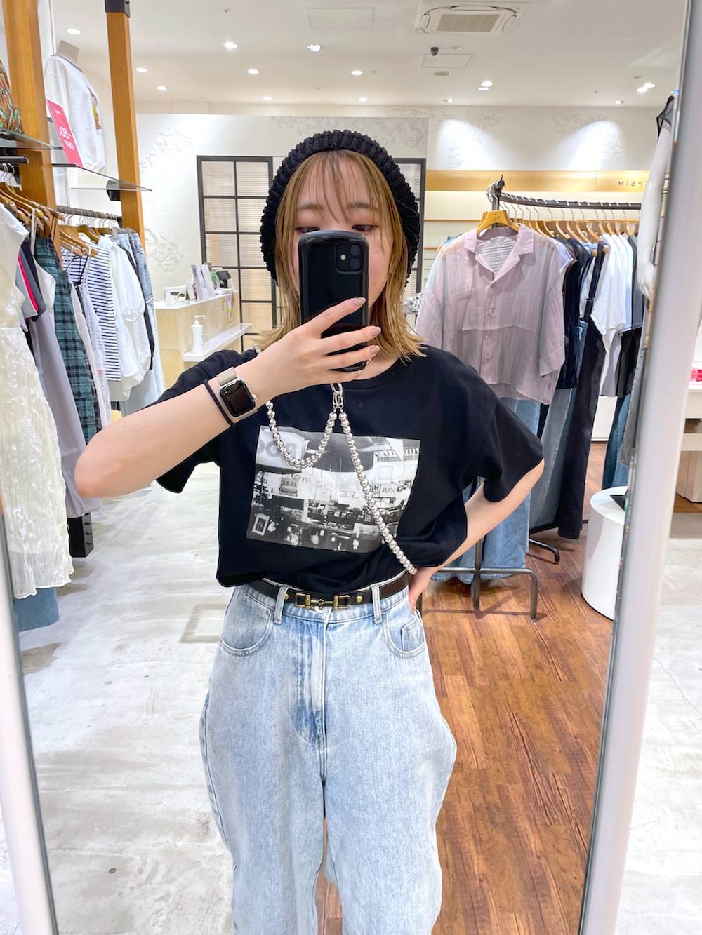 ブラック系のTシャツ/カットソー、ブルー系のデニムパンツ、シルバー系のスマホグッズを着用したレディースの夏コーディネートの2枚目の写真