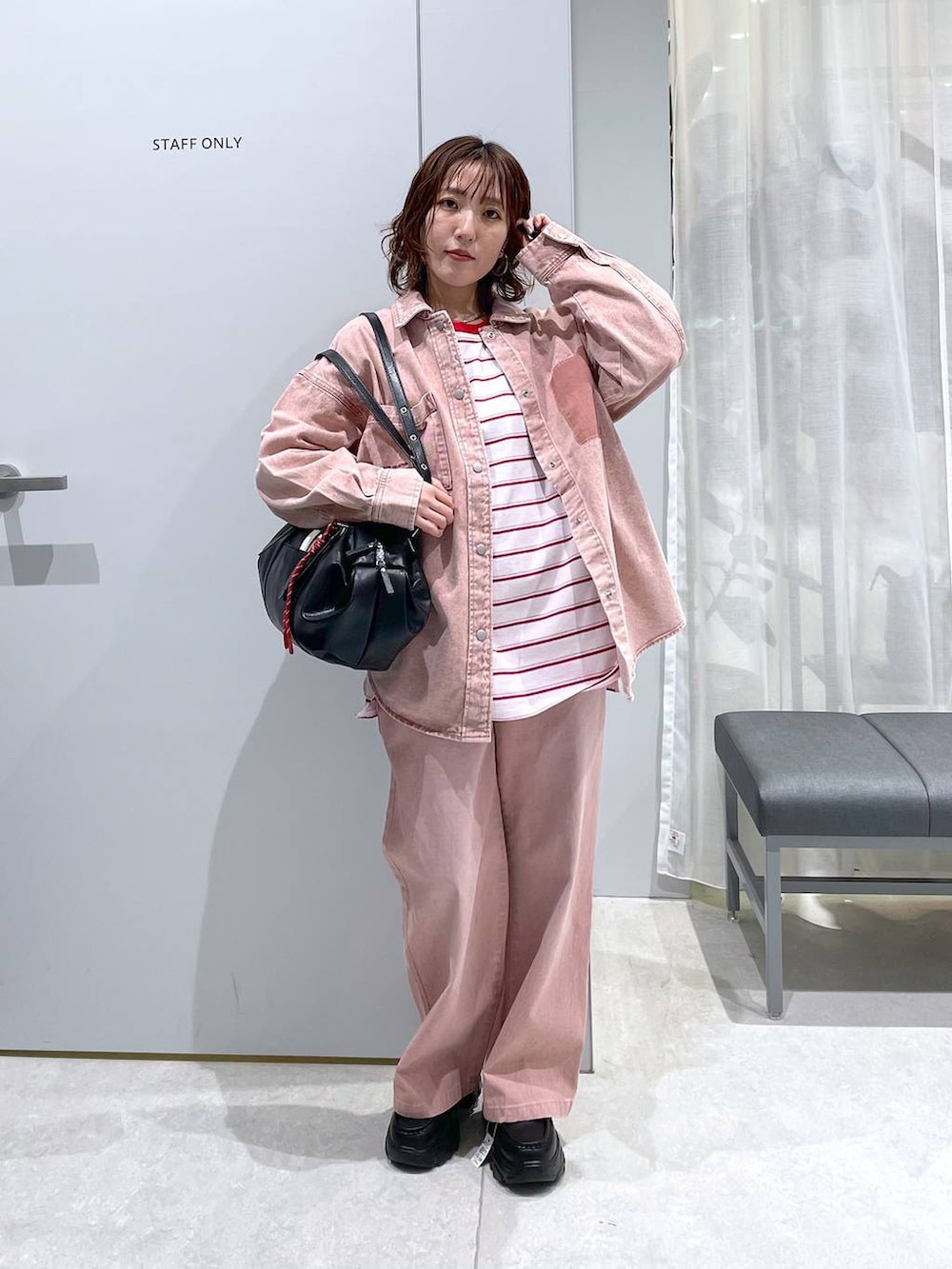 ピンク系のTシャツ/カットソー、ピンク系のシャツ/ブラウス、ブラック系のボストンバッグを着用したレディースの冬コーディネートの3枚目の写真