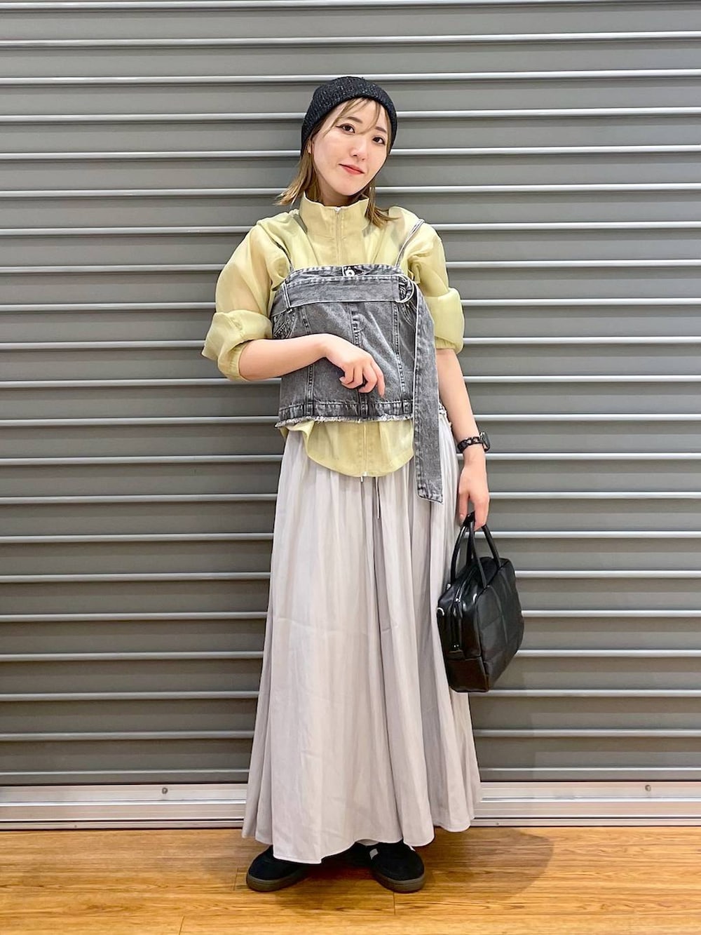 グレー系のベスト、グレー系のその他パンツ、ブラック系のスニーカーを着用したレディースの秋コーディネートの2枚目の写真