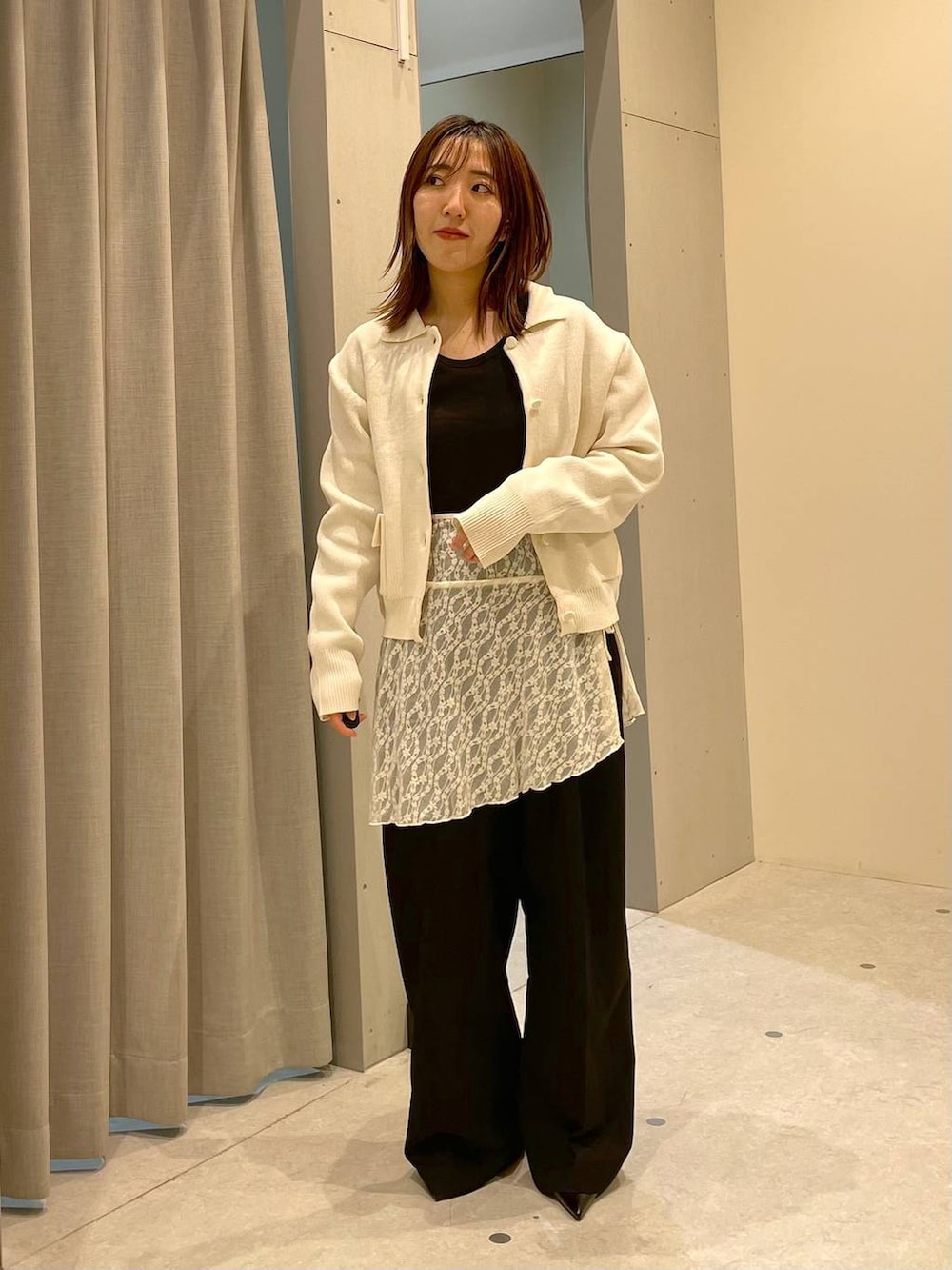 ブラック系のTシャツ/カットソー、ブラック系のスラックス、ブラック系のパンプスを着用したレディースの冬コーディネートの2枚目の写真