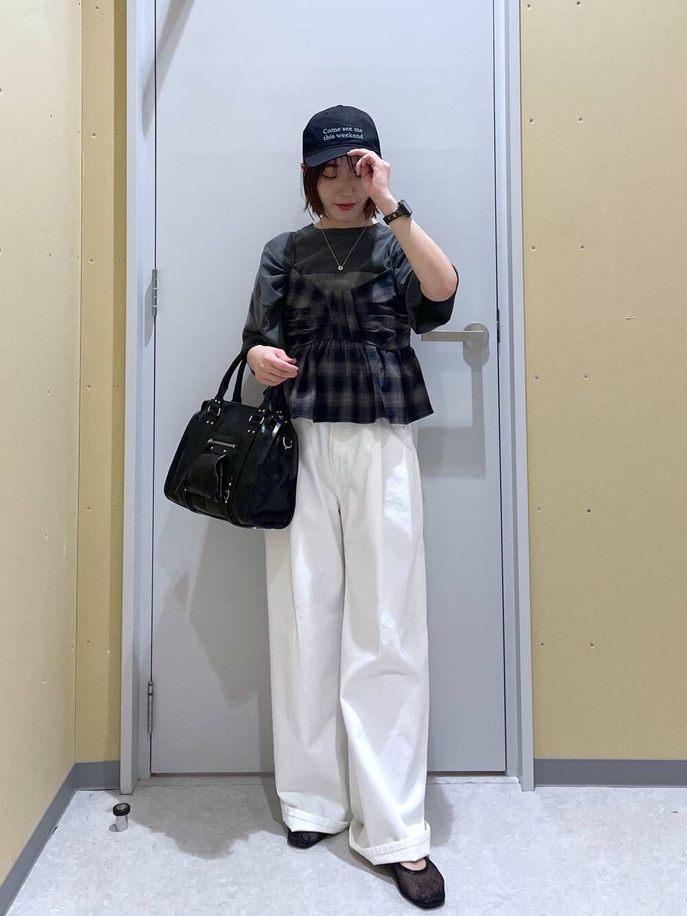 ホワイト系のデニムパンツ、ブラック系のボストンバッグ、グレー系のTシャツ/カットソーを着用したレディースの夏コーディネートの3枚目の写真