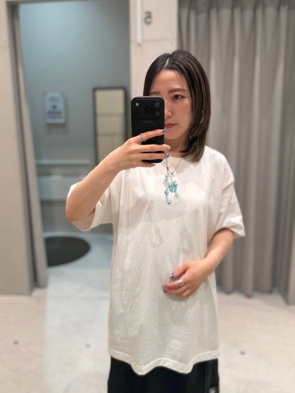 ホワイト系のTシャツ/カットソー、ブラック系のスカートを着用したレディースの夏コーディネートの2枚目の写真