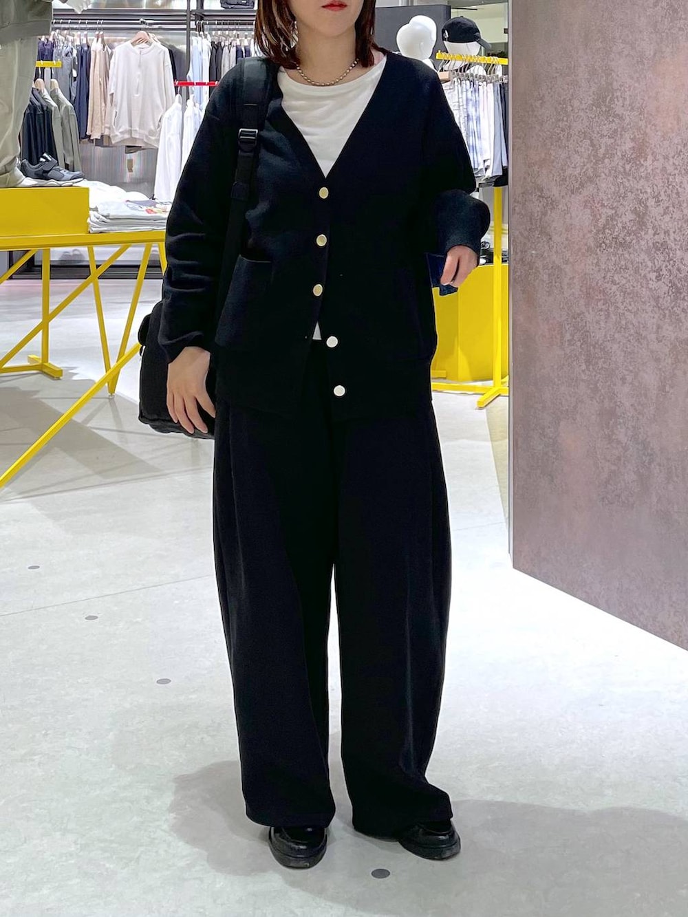 ブラック系のカーディガン/ボレロ、ブラック系のバックパック/リュック、ブラック系のスウェットパンツを着用したレディースの春コーディネートの2枚目の写真