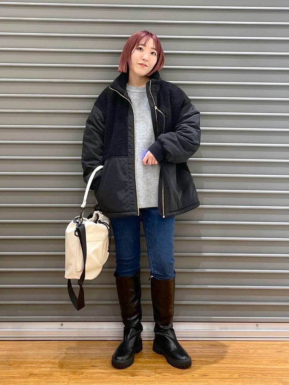 ブラック系のその他アウター、ブラック系のブーツ、グレー系のニット/セーターを着用したレディースの冬コーディネートの2枚目の写真