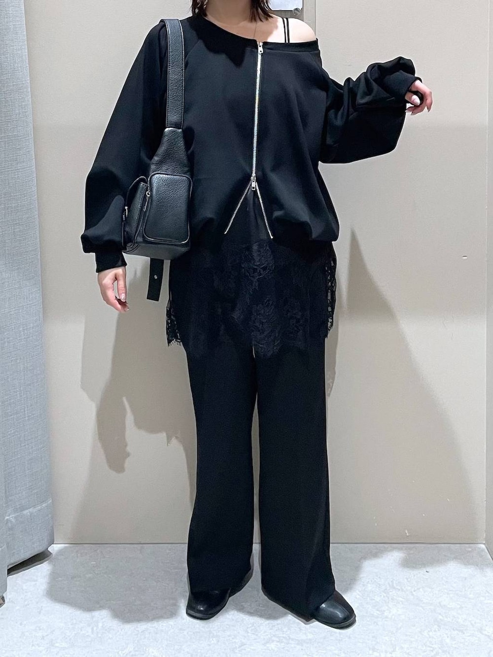 ブラック系のスウェット、ブラック系のその他パンツ、ブラック系のショルダーバッグを着用したレディースの冬コーディネートの2枚目の写真