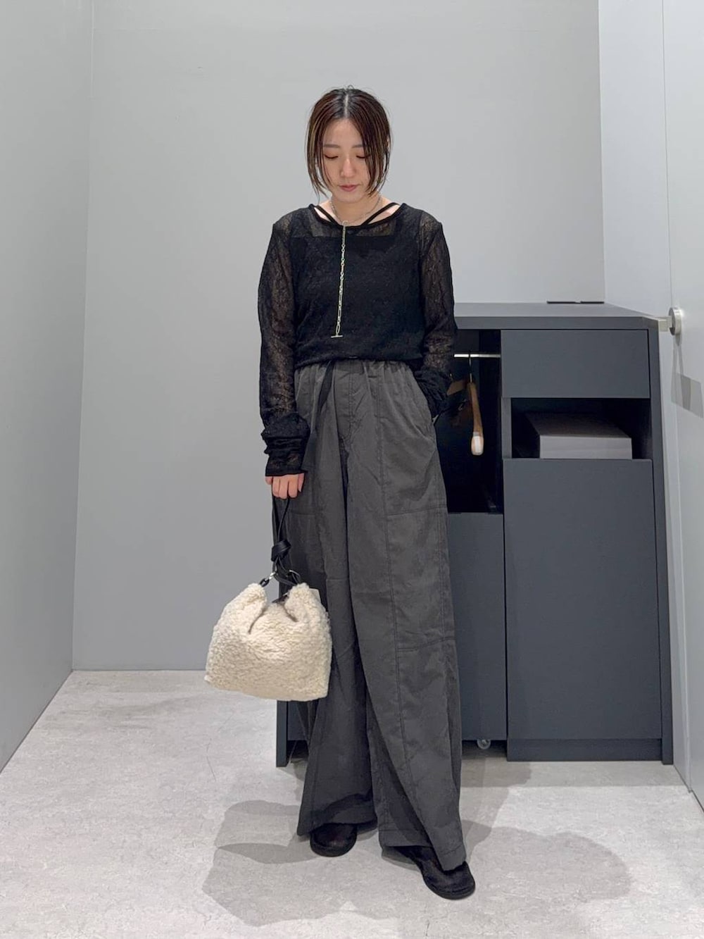 ホワイト系のショルダーバッグ、ブラック系のTシャツ/カットソー、ブラック系のタンクトップを着用したレディースの夏コーディネートの2枚目の写真