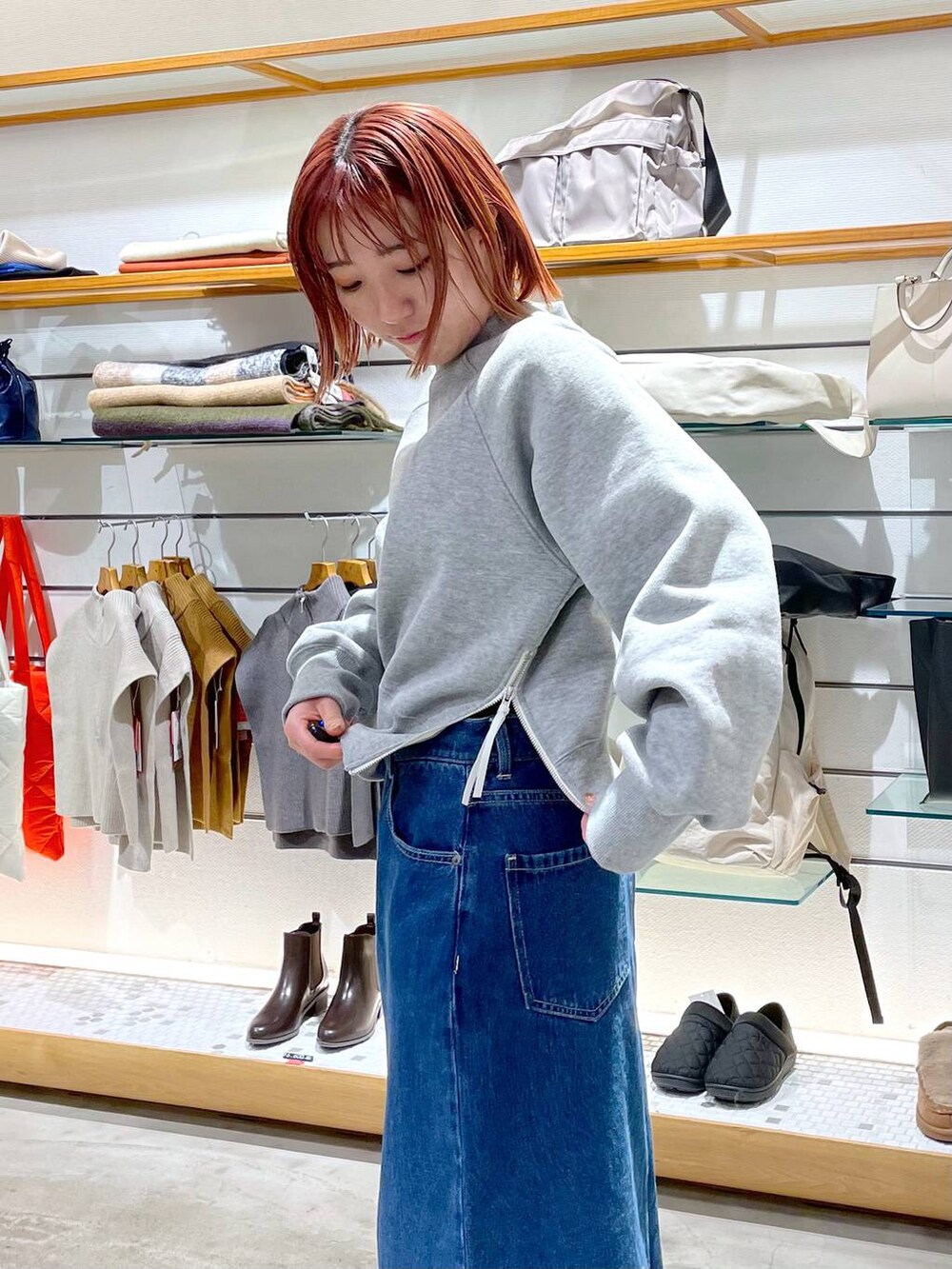 ブラック系のニット/セーター、ベージュ系のブーツ、ホワイト系のバックパック/リュックを着用したレディースの冬コーディネートの3枚目の写真