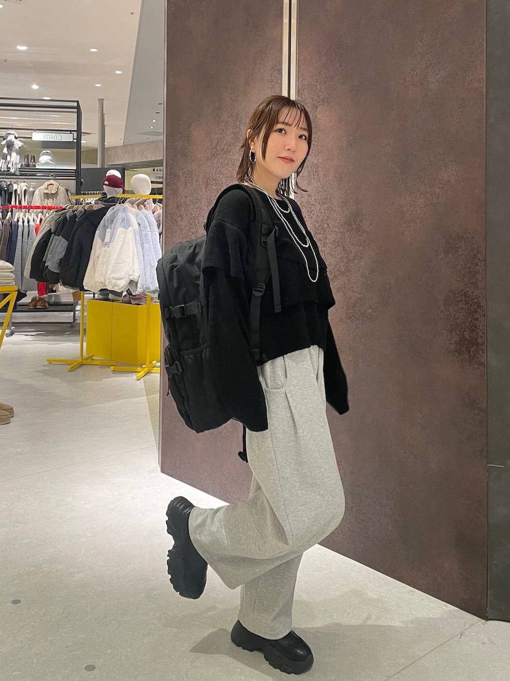 ブラック系のバックパック/リュック、グレー系のスウェットパンツ、ブラック系のニット/セーターを着用したレディースの冬コーディネートの3枚目の写真