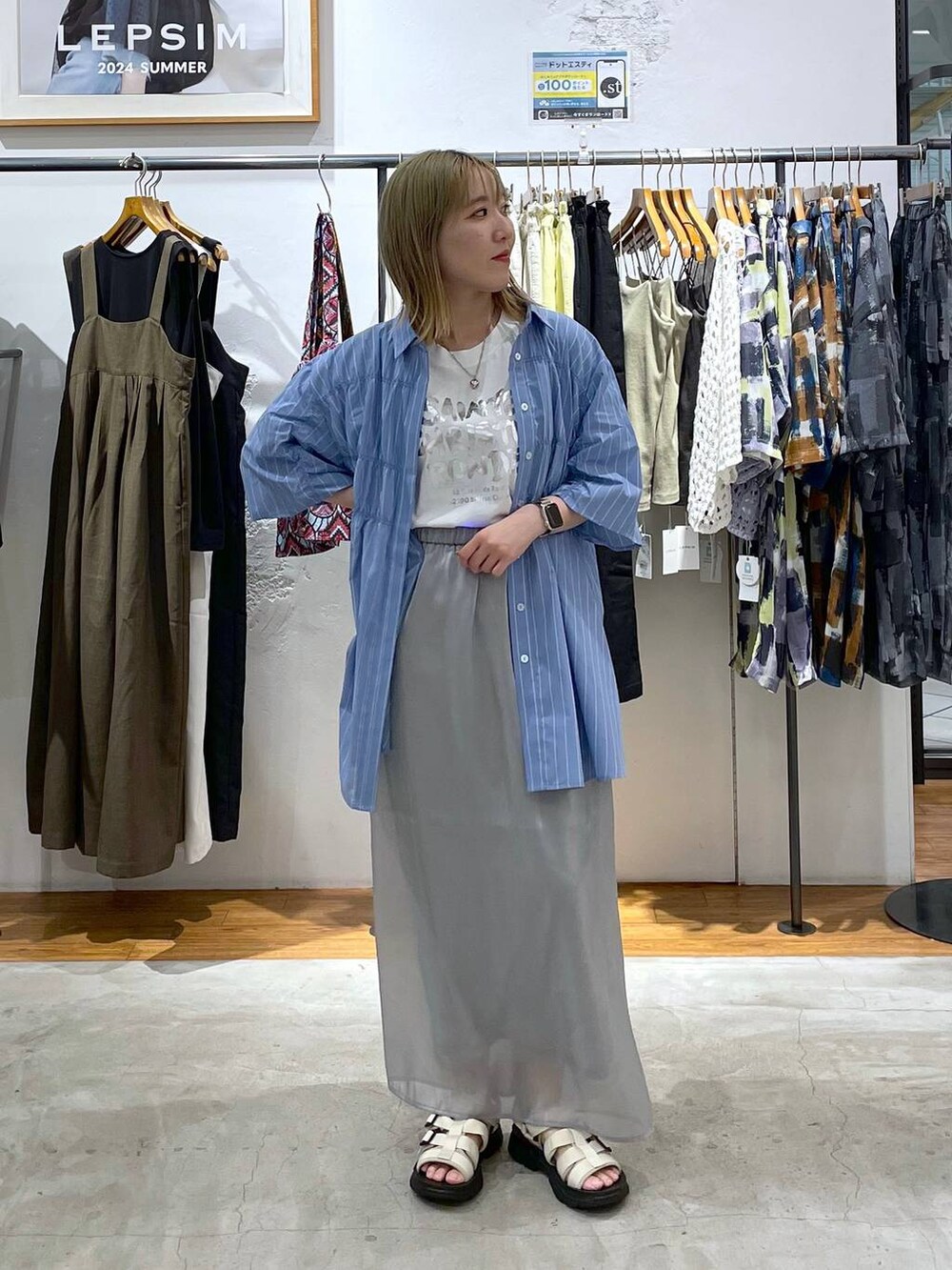 グレー系のスカート、ホワイト系のサンダル、ホワイト系のTシャツ/カットソーを着用したレディースの夏コーディネートの3枚目の写真