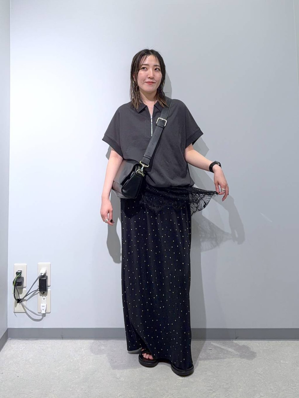 ブラック系のショルダーバッグ、ブラック系のサンダル、その他のスカートを着用したレディースの夏コーディネートの2枚目の写真