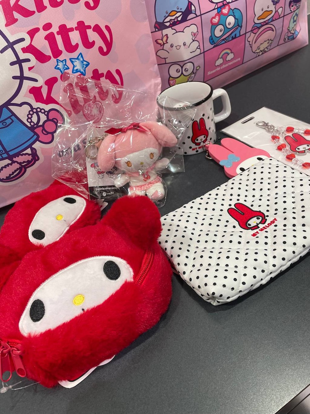 ピンク系のキーホルダー、レッド系のポーチ、レッド系のスマホグッズを着用したレディースの秋コーディネートの2枚目の写真