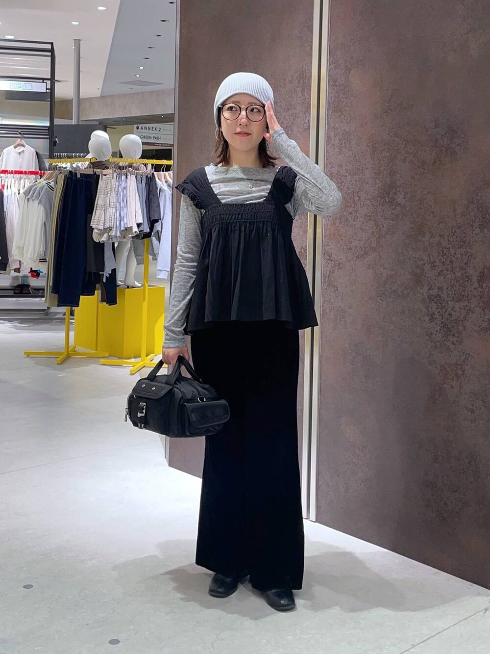 ブラック系のベストを着用したレディースの春コーディネートの2枚目の写真