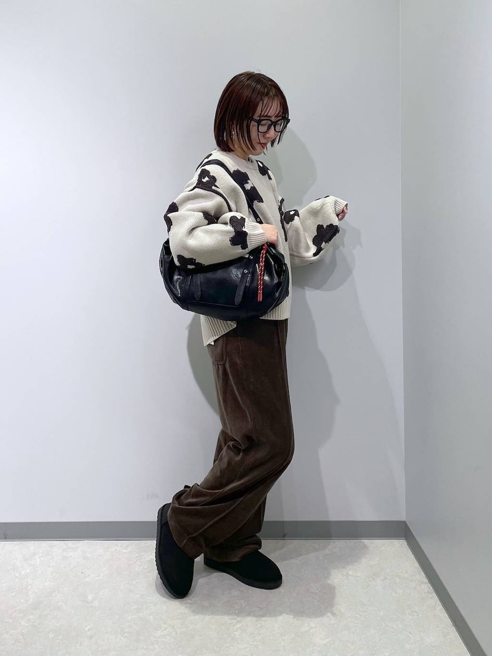 ブラウン系のその他パンツ、ベージュ系のニット/セーター、ブラック系のブーツを着用したレディースの冬コーディネートの3枚目の写真