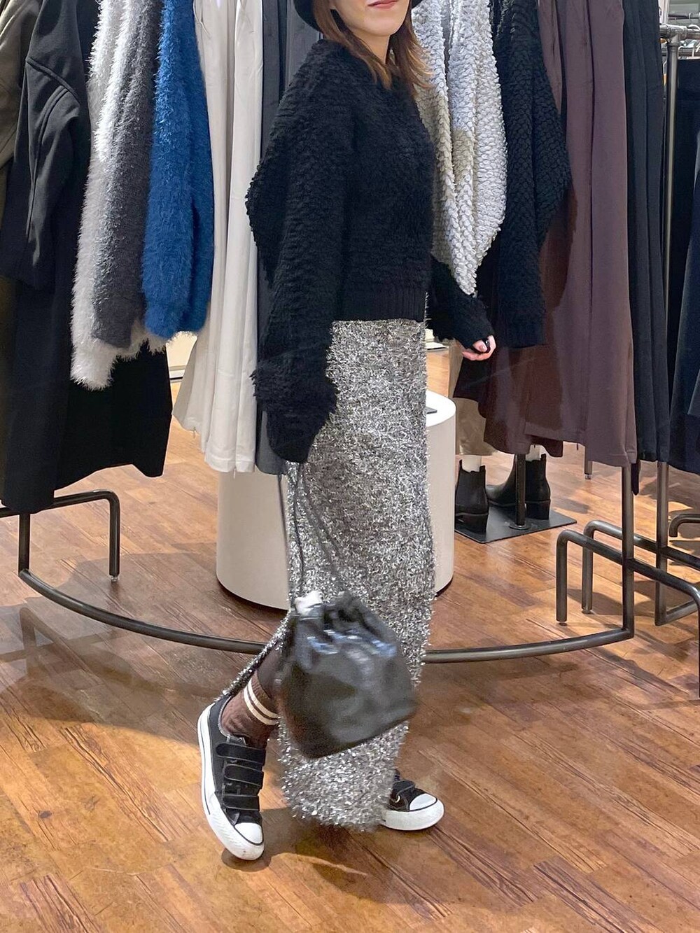 ブラック系のショルダーバッグ、ブラック系のスカート、ブラック系のカーディガン/ボレロを着用したレディースの冬コーディネートの3枚目の写真