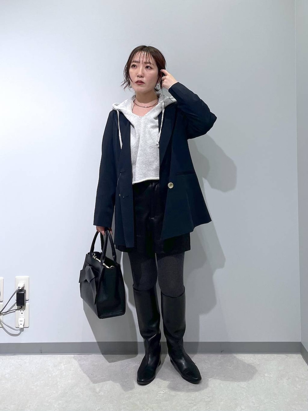 ブラック系のその他パンツ、ブルー系のテーラードジャケット、ブラック系のハンドバッグを着用したレディースの冬コーディネートの5枚目の写真