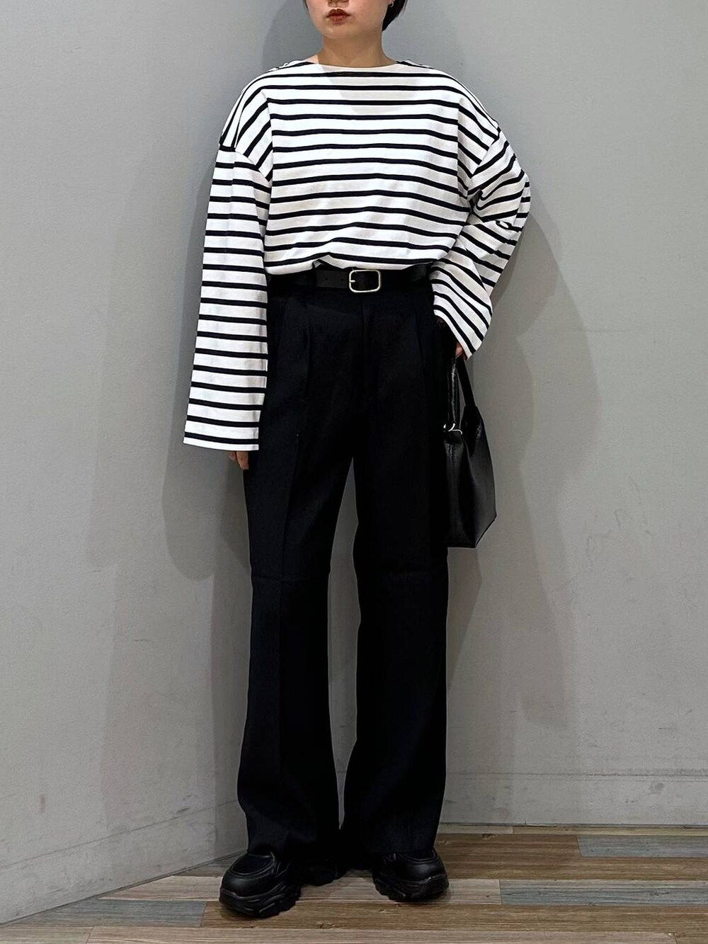 ブラック系のその他パンツ、ブルー系のTシャツ/カットソー、ブラック系のスニーカーを着用したレディースの春コーディネートの3枚目の写真