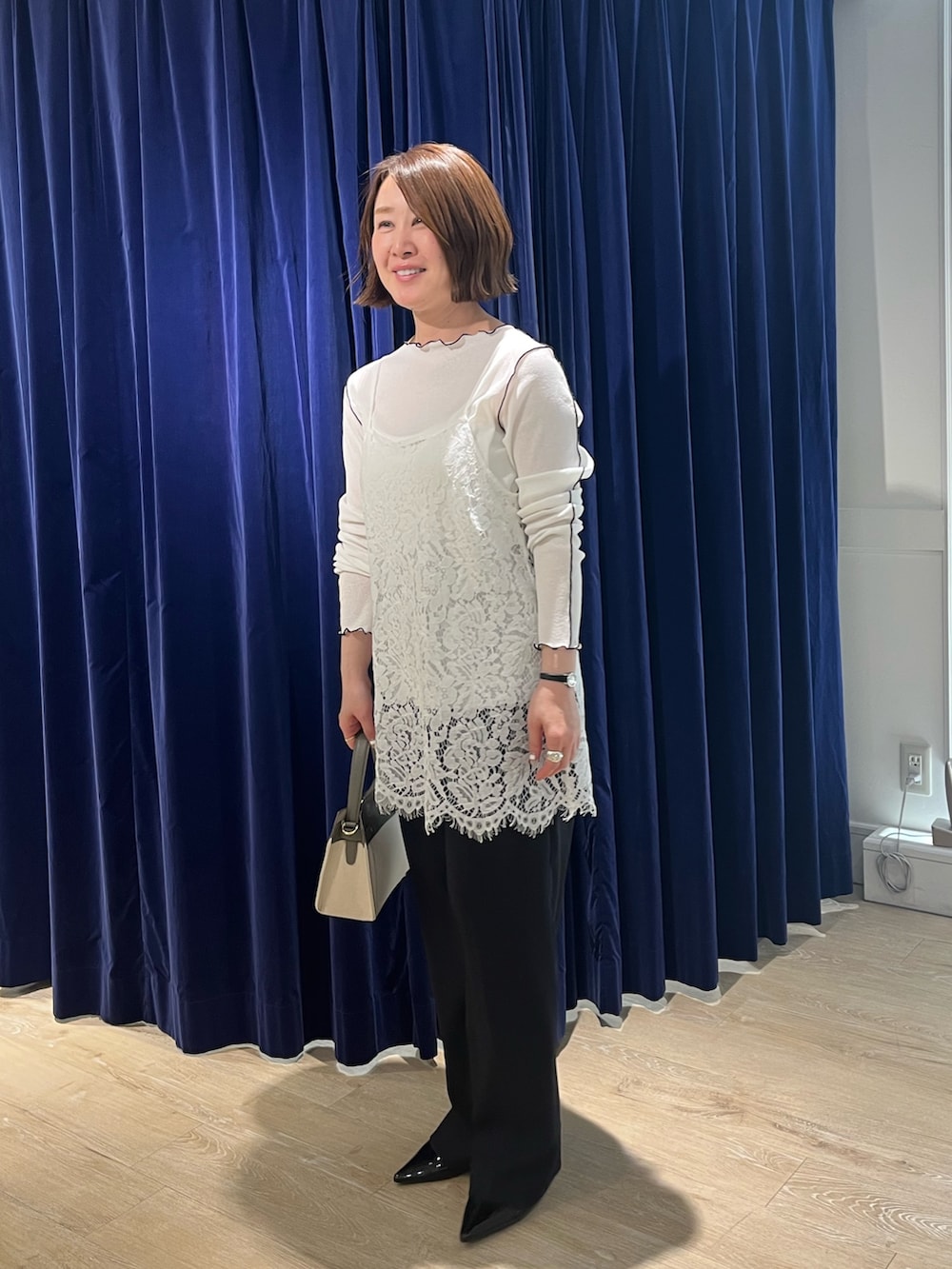 ホワイト系のキャミソール、ホワイト系のTシャツ/カットソー、ベージュ系のショルダーバッグを着用したレディースの春コーディネートの6枚目の写真