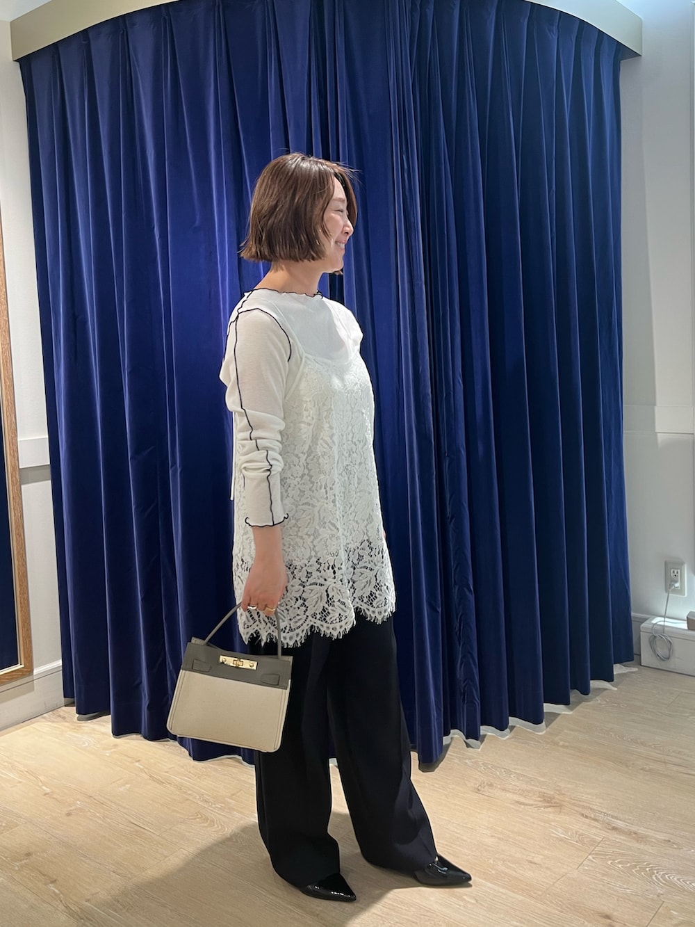 ホワイト系のキャミソール、ホワイト系のTシャツ/カットソー、ベージュ系のショルダーバッグを着用したレディースの春コーディネートの2枚目の写真