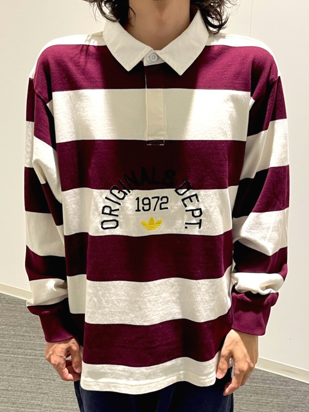 ホワイト系のポロシャツ、ブルー系のスニーカーを着用したメンズの秋コーディネートの3枚目の写真