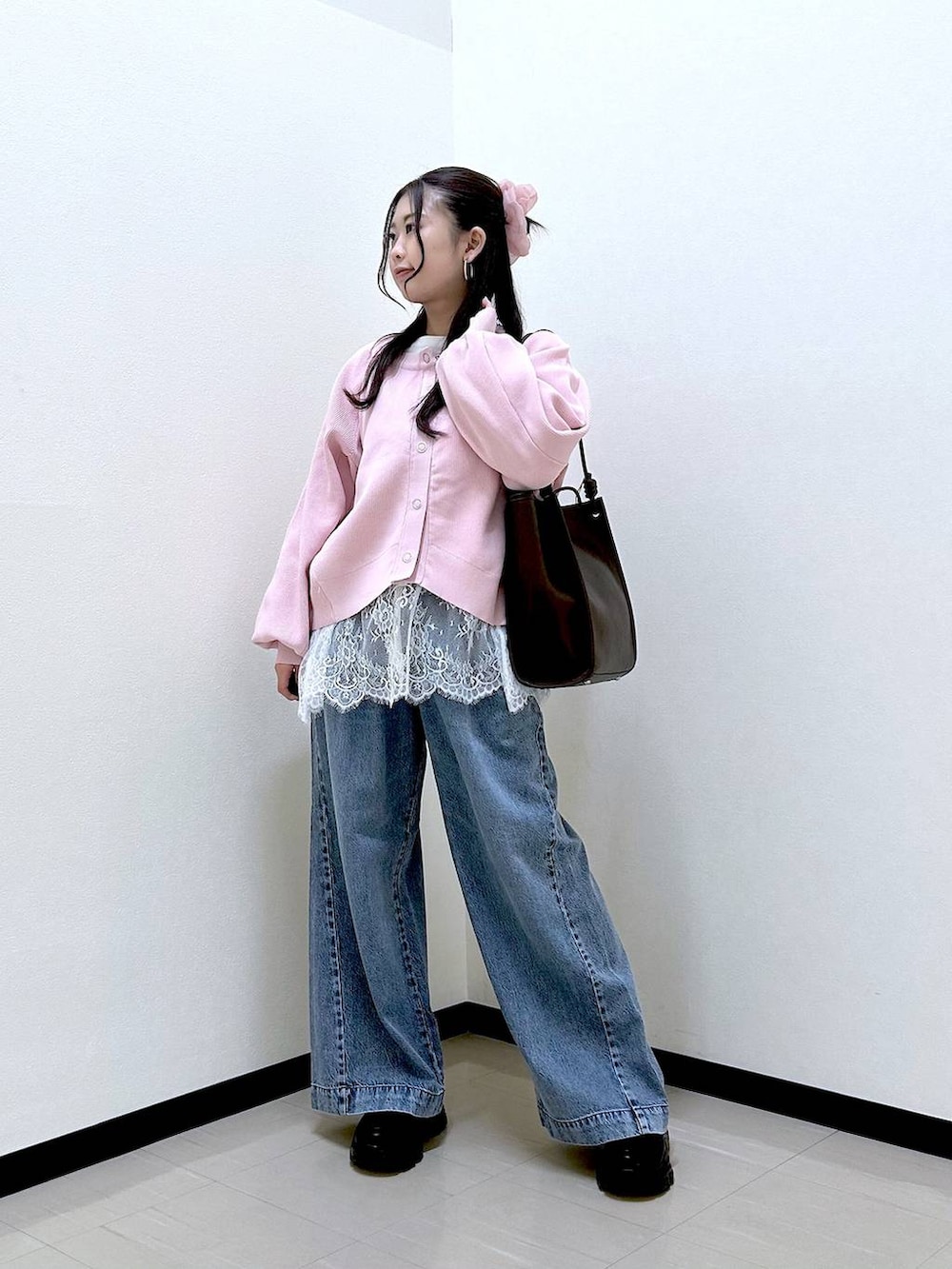 ブルー系のデニムパンツ、ブラック系のローファー、ブラウン系のトートバッグを着用したレディースの春コーディネートの2枚目の写真