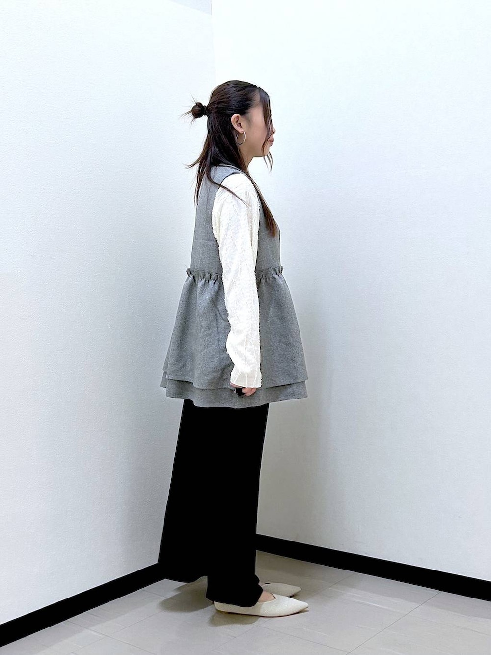 ベージュ系のTシャツ/カットソー、ブラック系のスカート、ホワイト系のパンプスを着用したレディースの春コーディネートの5枚目の写真