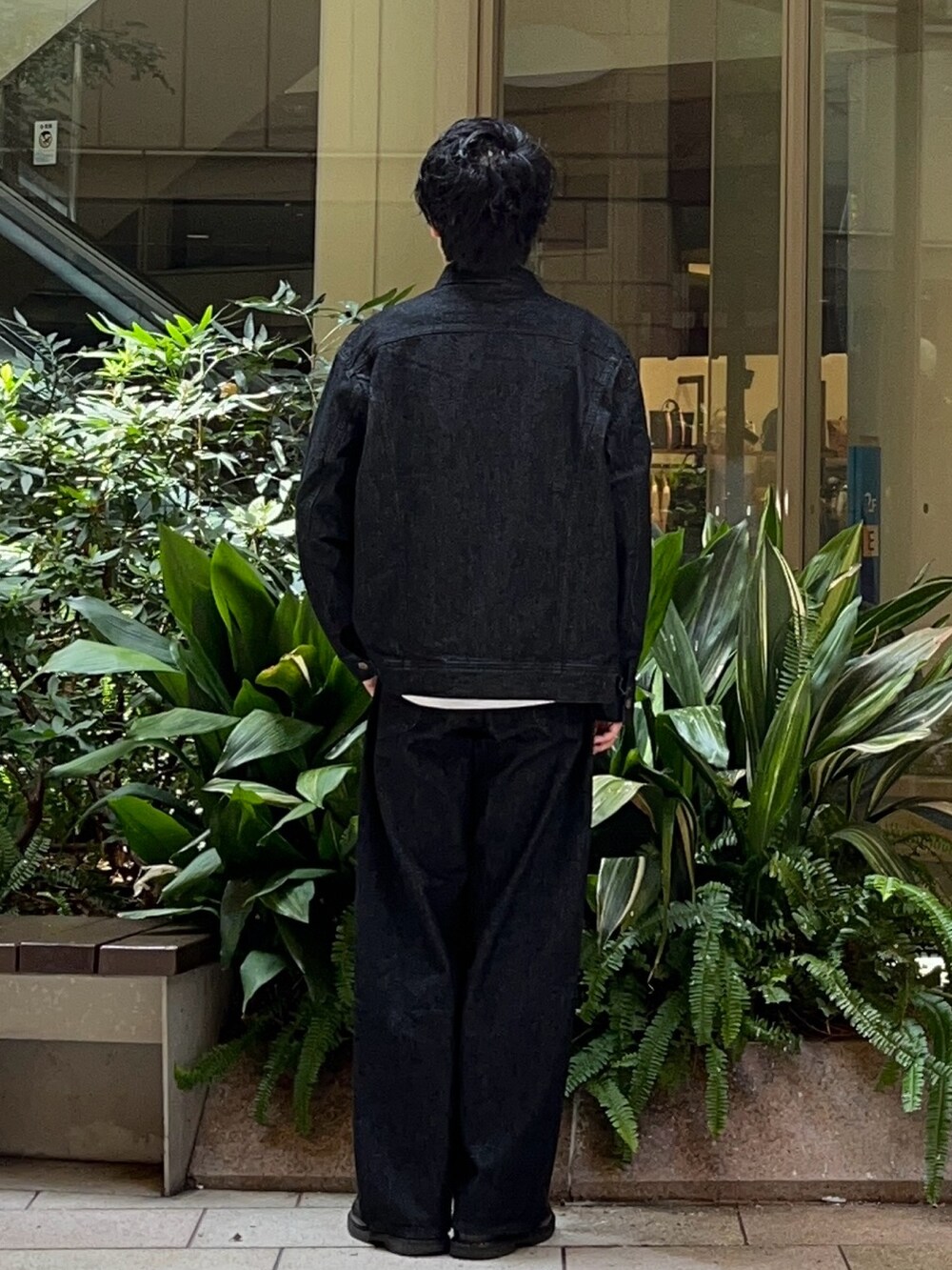 ブラック系のデニムジャケット、ブラック系のデニムパンツ、ブラック系のローファーを着用したメンズの秋コーディネートの3枚目の写真