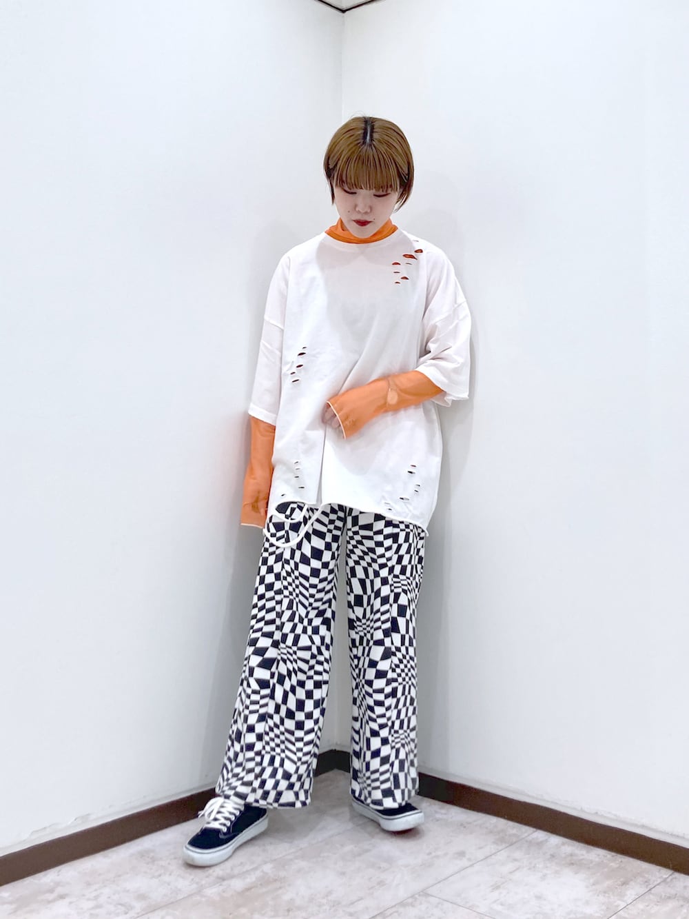 ホワイト系のTシャツ/カットソー、オレンジ系のTシャツ/カットソー、ホワイト系のスラックスを着用したレディースの春コーディネートの2枚目の写真