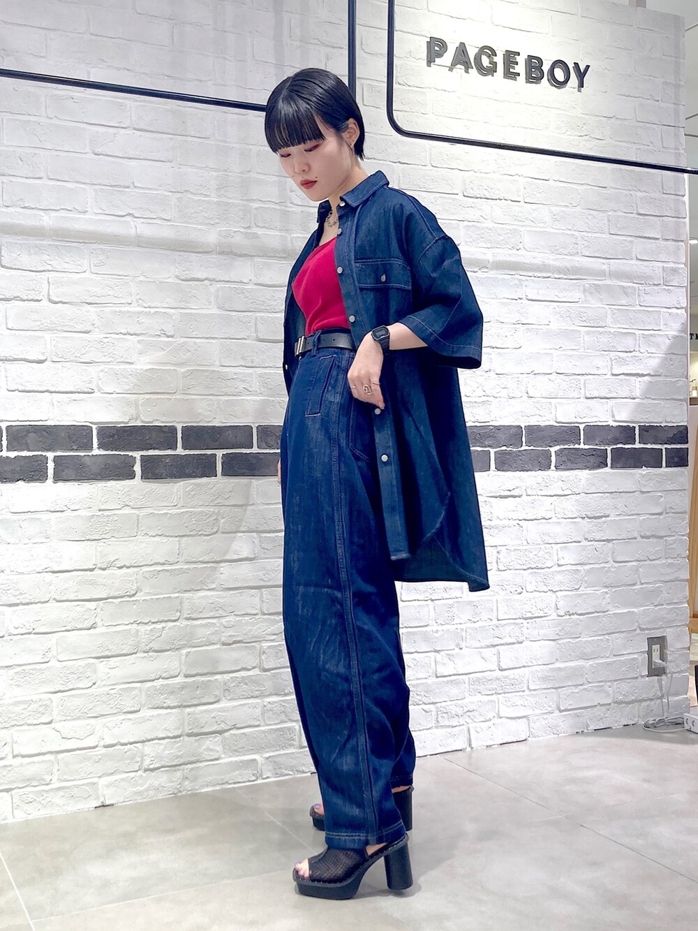 ブルー系のデニムパンツ、ブラック系のサンダル、ブルー系のシャツ/ブラウスを着用したレディースの夏コーディネートの4枚目の写真