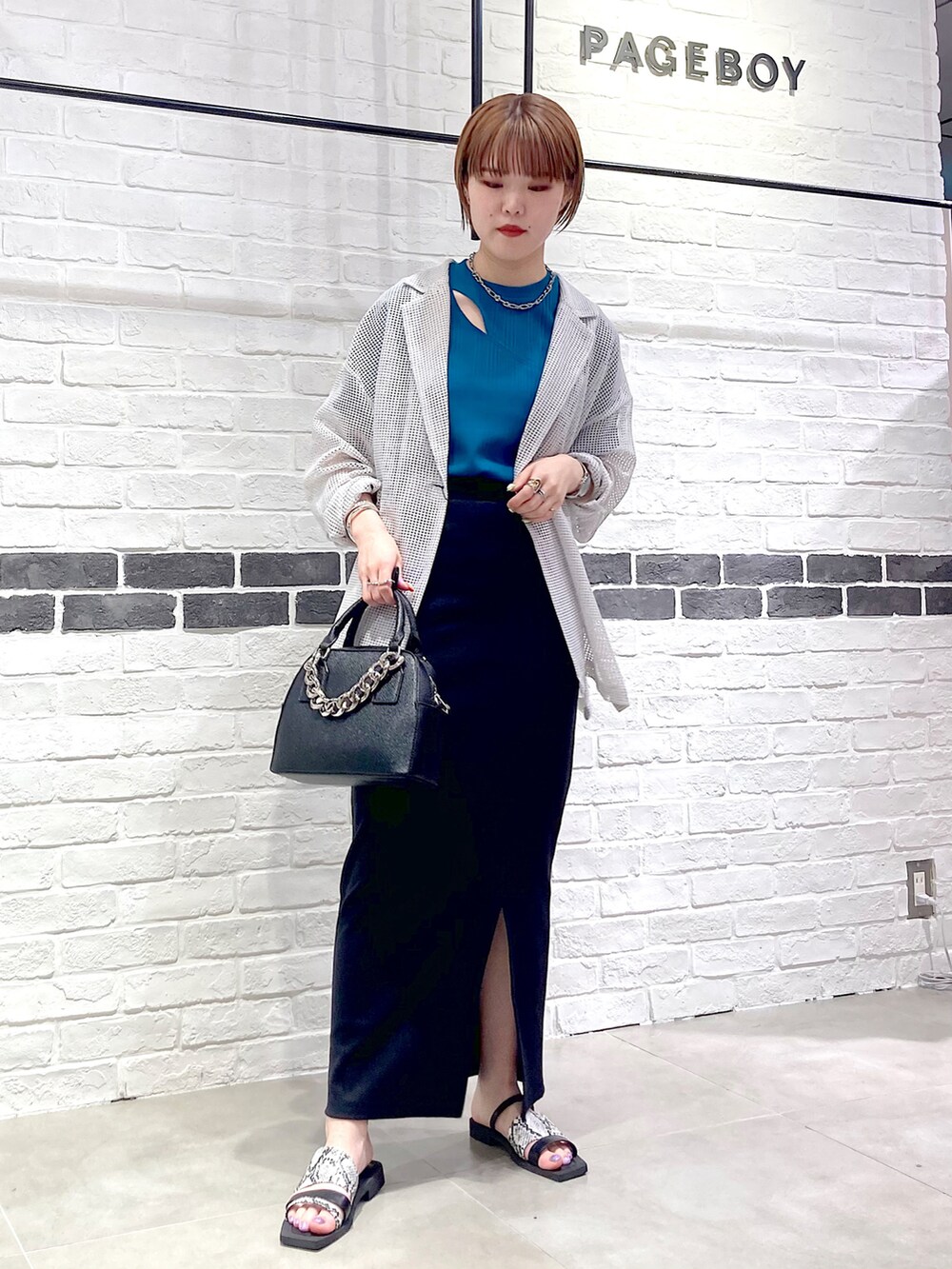 ブラック系のサンダル、ブラック系のショルダーバッグ、ベージュ系のテーラードジャケットを着用したレディースの春コーディネートの2枚目の写真