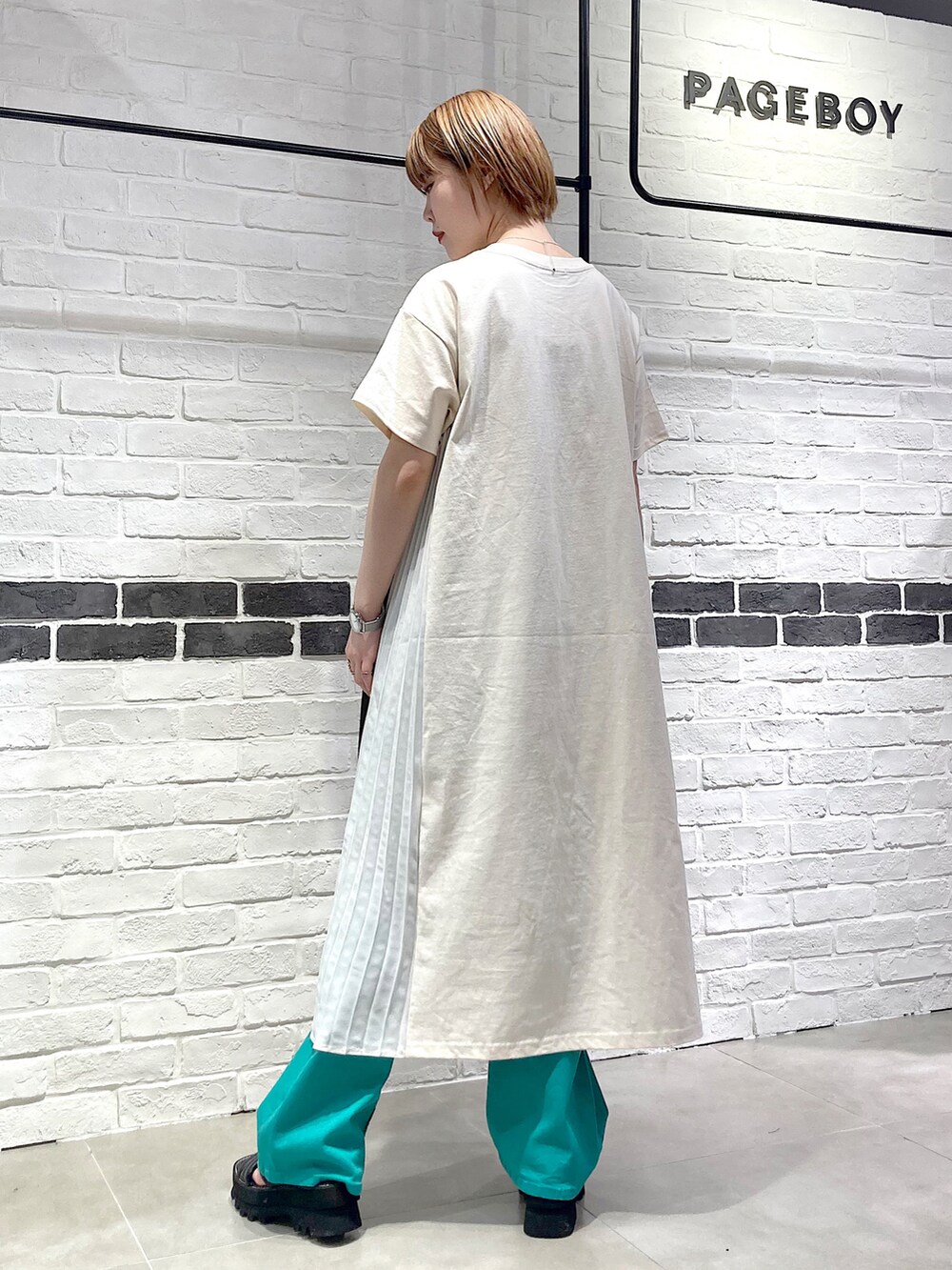 その他のショルダーバッグ、ホワイト系のワンピース、グリーン系のデニムパンツを着用したレディースの春コーディネートの5枚目の写真