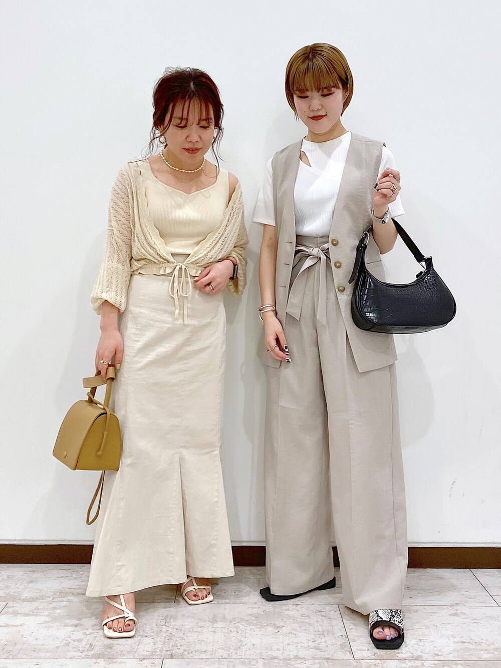 ホワイト系のTシャツ/カットソー、ベージュ系のその他アウター、ブラック系のショルダーバッグを着用したレディースの春コーディネートの2枚目の写真