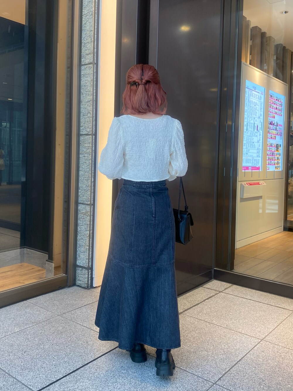 ホワイト系のシャツ/ブラウス、ベージュ系のタンクトップ、ブラック系のスカートを着用したレディースの春コーディネートの4枚目の写真