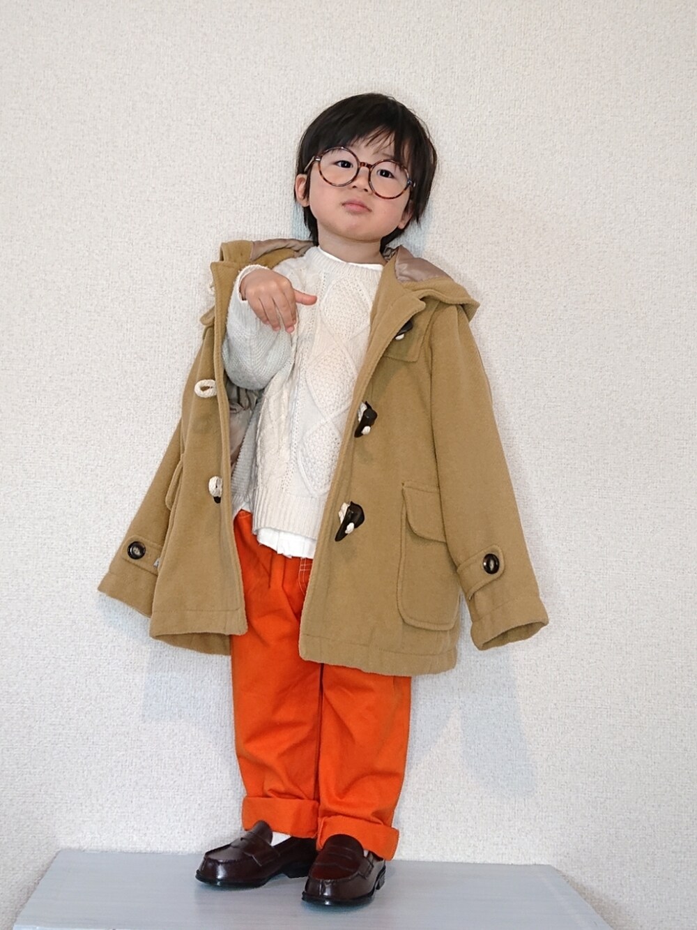 ホワイト系のニット/セーター、ホワイト系のシャツ/ブラウス、ベージュ系のダッフルコートを着用したキッズの冬コーディネートの4枚目の写真