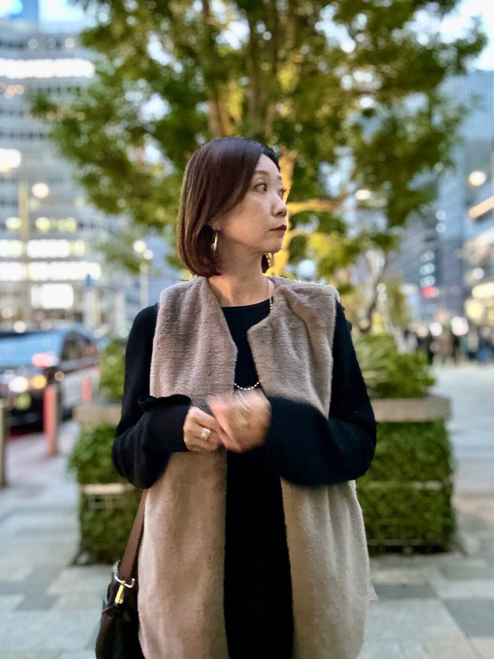 ブラック系のブーツ、ブラウン系のベスト、シルバー系のネックレスを着用したレディースの秋コーディネートの5枚目の写真