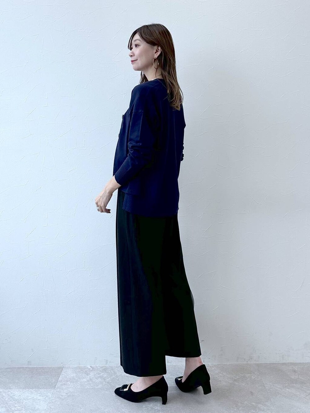 グレー系のパンプス、ブルー系のその他パンツ、ブラック系のハンドバッグを着用したレディースの冬コーディネートの3枚目の写真