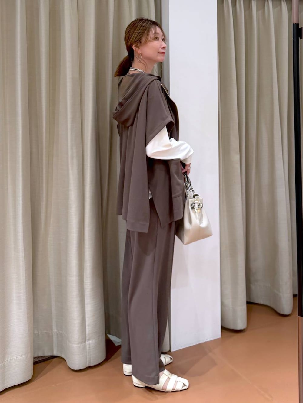 ブラウン系のその他パンツ、ホワイト系のパンプス、ホワイト系のTシャツ/カットソーを着用したレディースの春コーディネートの5枚目の写真