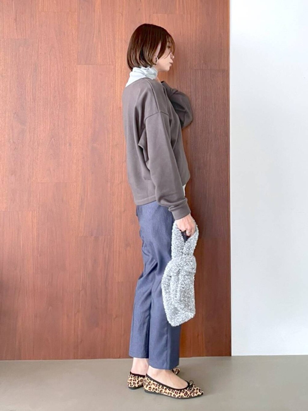 ブラウン系のパンプス、ブルー系のデニムパンツ、シルバー系のネックレスを着用したレディースの夏コーディネートの5枚目の写真