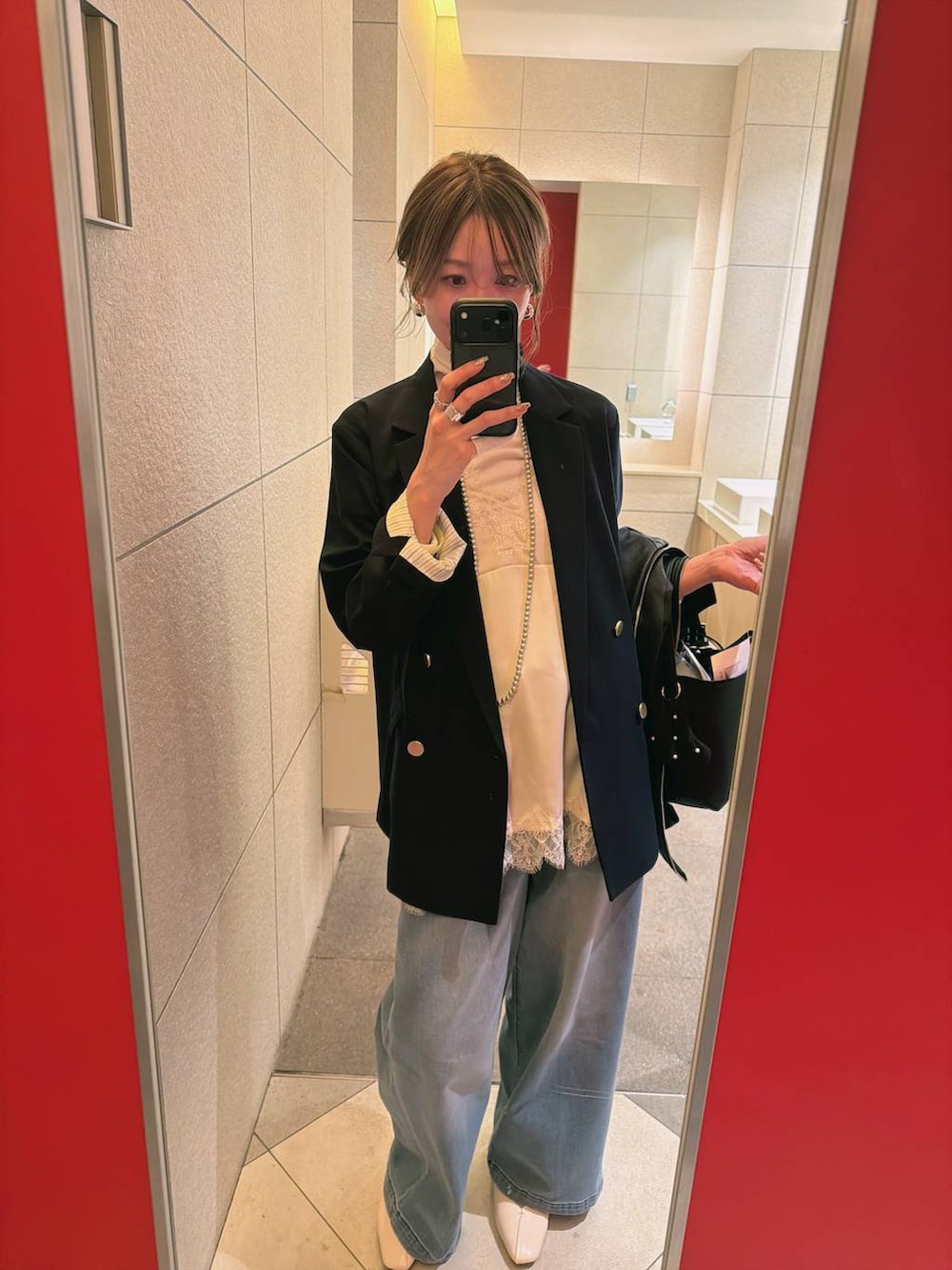 ホワイト系のTシャツ/カットソー、ホワイト系のパンプス、ブルー系のデニムパンツを着用したレディースの冬コーディネートの3枚目の写真