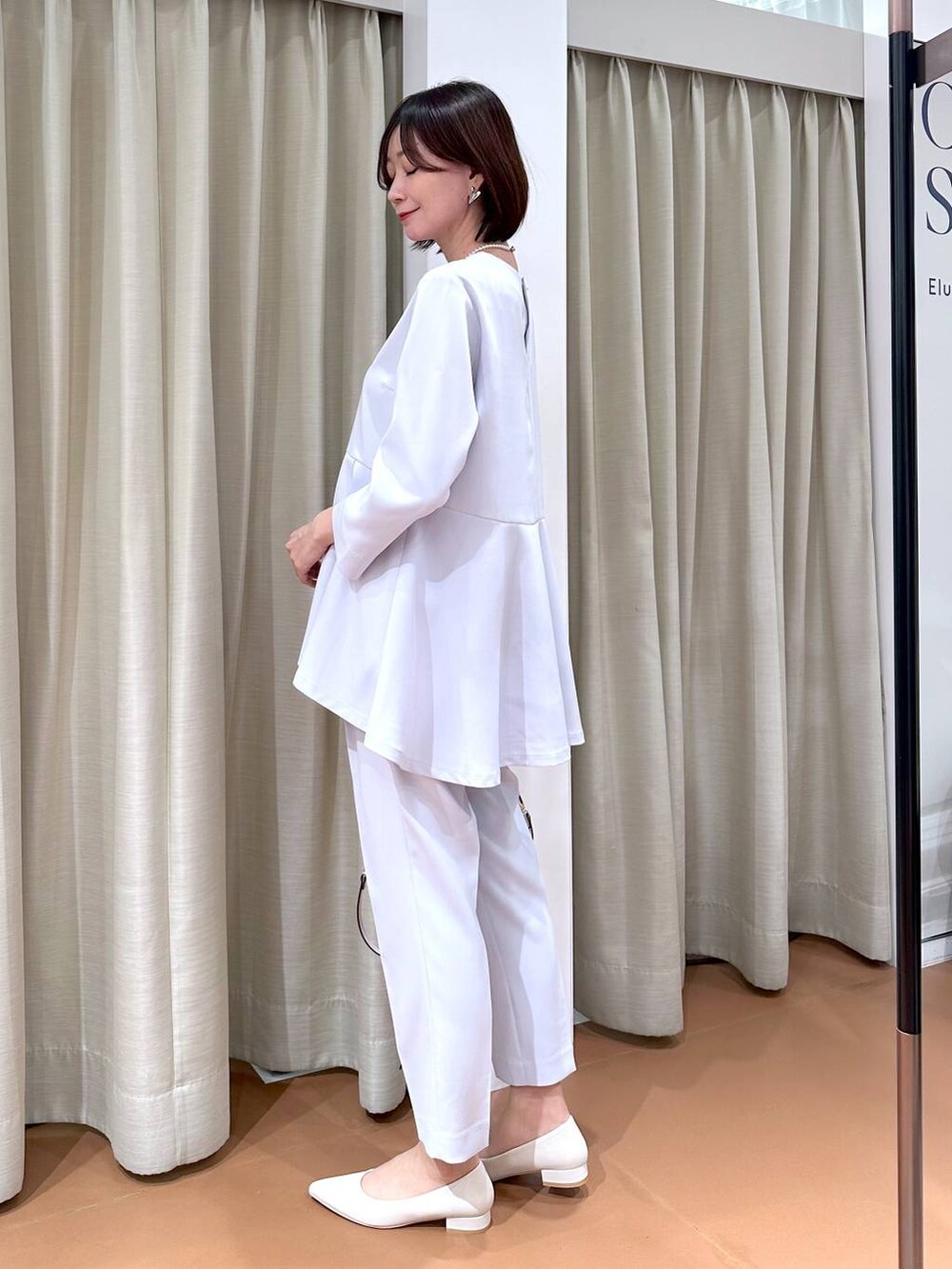 ブルー系のスーツパンツ、ブルー系のシャツ/ブラウス、ホワイト系のハンドバッグを着用したレディースの冬コーディネートの3枚目の写真