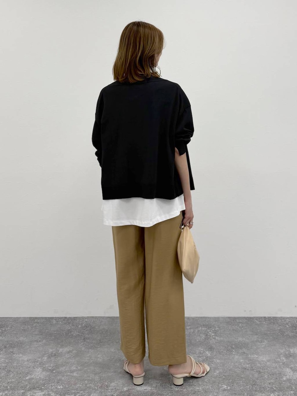 ベージュ系のその他パンツ、ブラック系のカーディガン/ボレロ、ホワイト系のTシャツ/カットソーを着用したレディースの春コーディネートの4枚目の写真