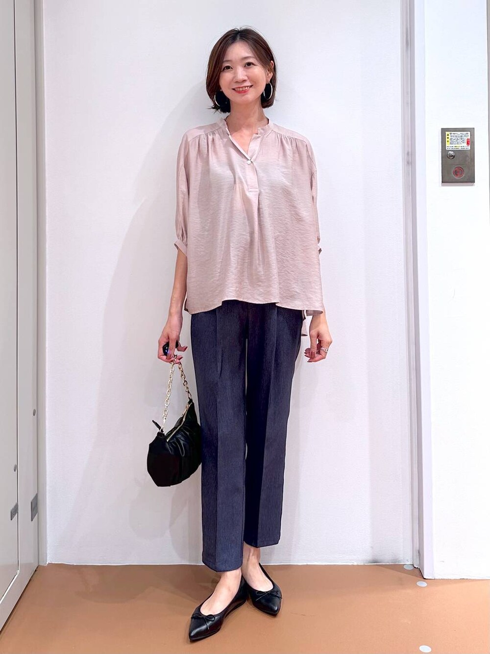 ベージュ系のシャツ/ブラウス、ブラック系のパンプス、ブルー系のデニムパンツを着用したレディースの秋コーディネートの2枚目の写真