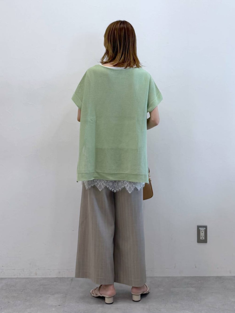 ホワイト系のサンダル、ベージュ系のその他パンツ、ホワイト系のTシャツ/カットソーを着用したレディースの春コーディネートの4枚目の写真