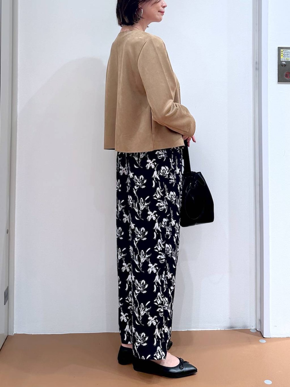 ブラック系のパンプス、ブルー系のその他パンツ、ホワイト系のTシャツ/カットソーを着用したレディースの秋コーディネートの6枚目の写真