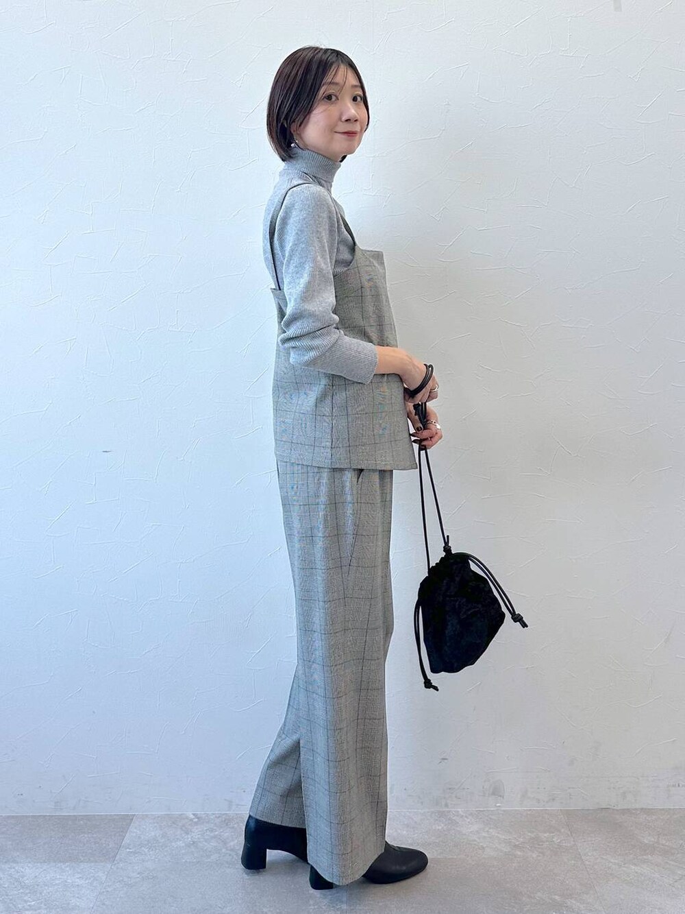 ブラック系のブーツ、グレー系のニット/セーターを着用したレディースの冬コーディネートの3枚目の写真