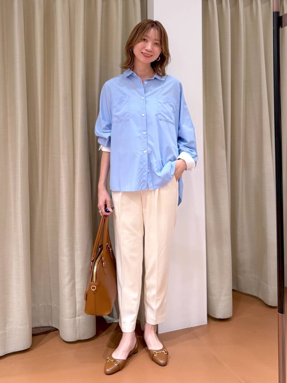 ホワイト系のその他パンツ、イエロー系のハンドバッグ、ブルー系のシャツ/ブラウスを着用したレディースの春コーディネートの2枚目の写真