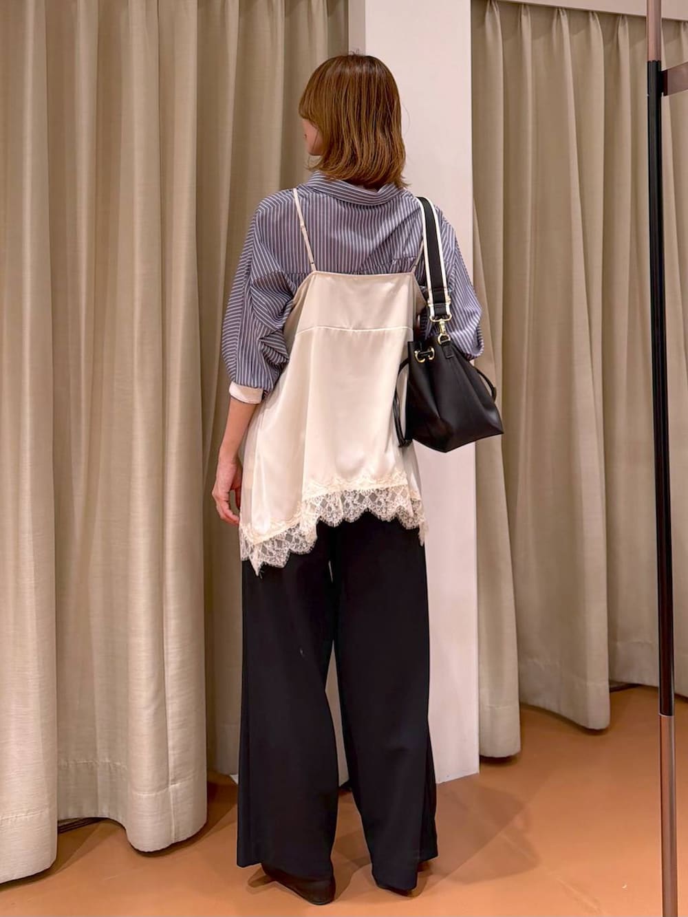 ブラック系のその他パンツ、ブラック系のパンプス、ホワイト系のキャミソールを着用したレディースの春コーディネートの4枚目の写真