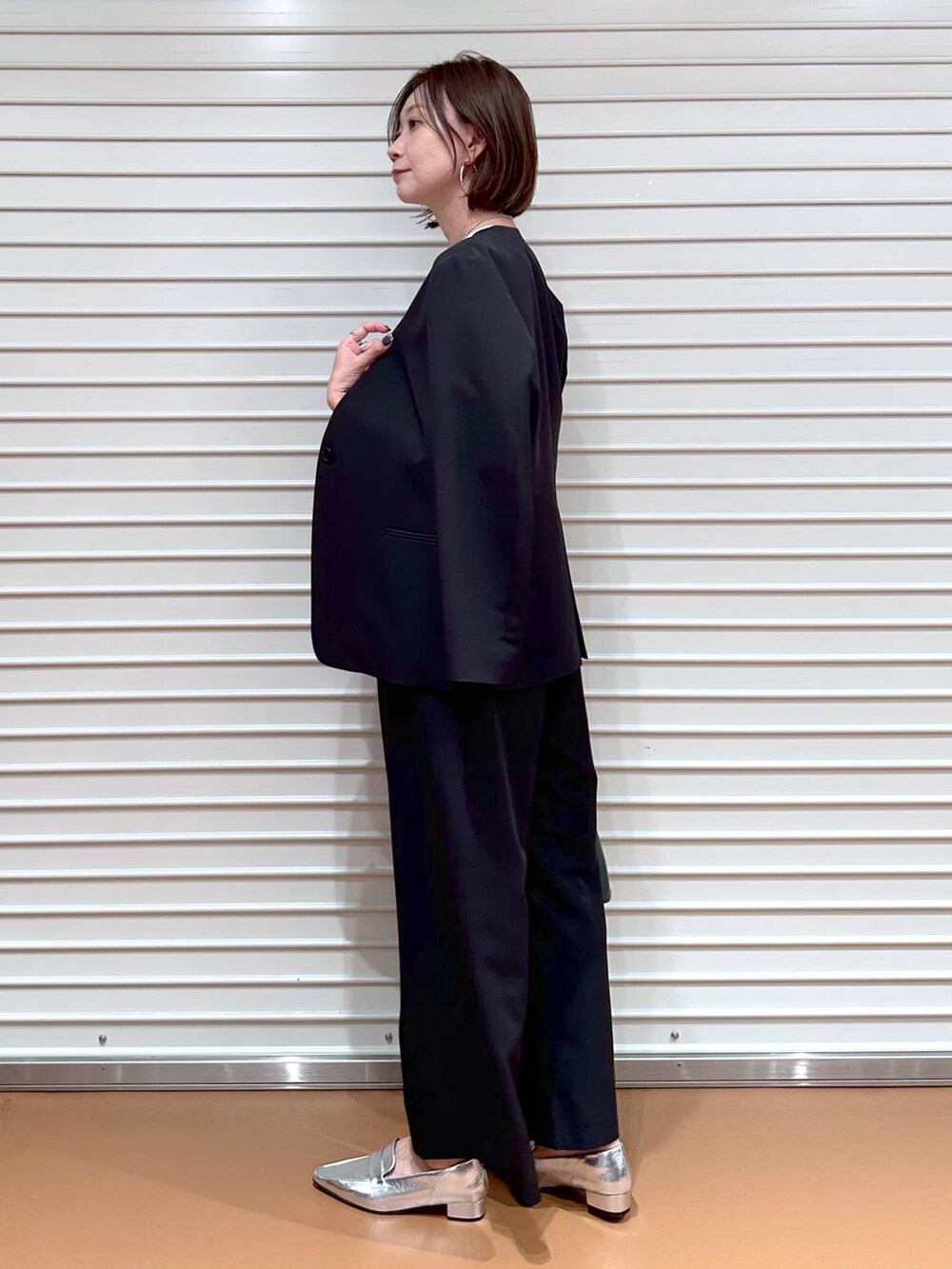 ブラック系のその他アウター、ブラック系のその他パンツ、ホワイト系のTシャツ/カットソーを着用したレディースの秋コーディネートの3枚目の写真